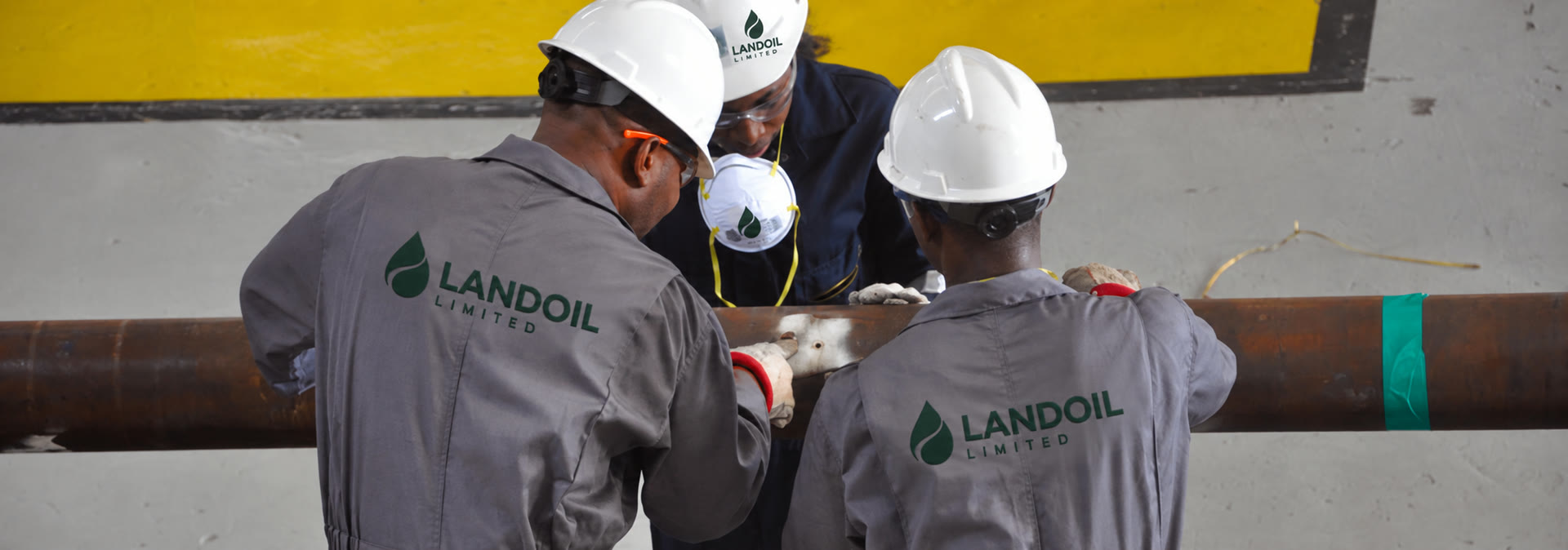 LANDOIL technicians inspecting oilfield equipment